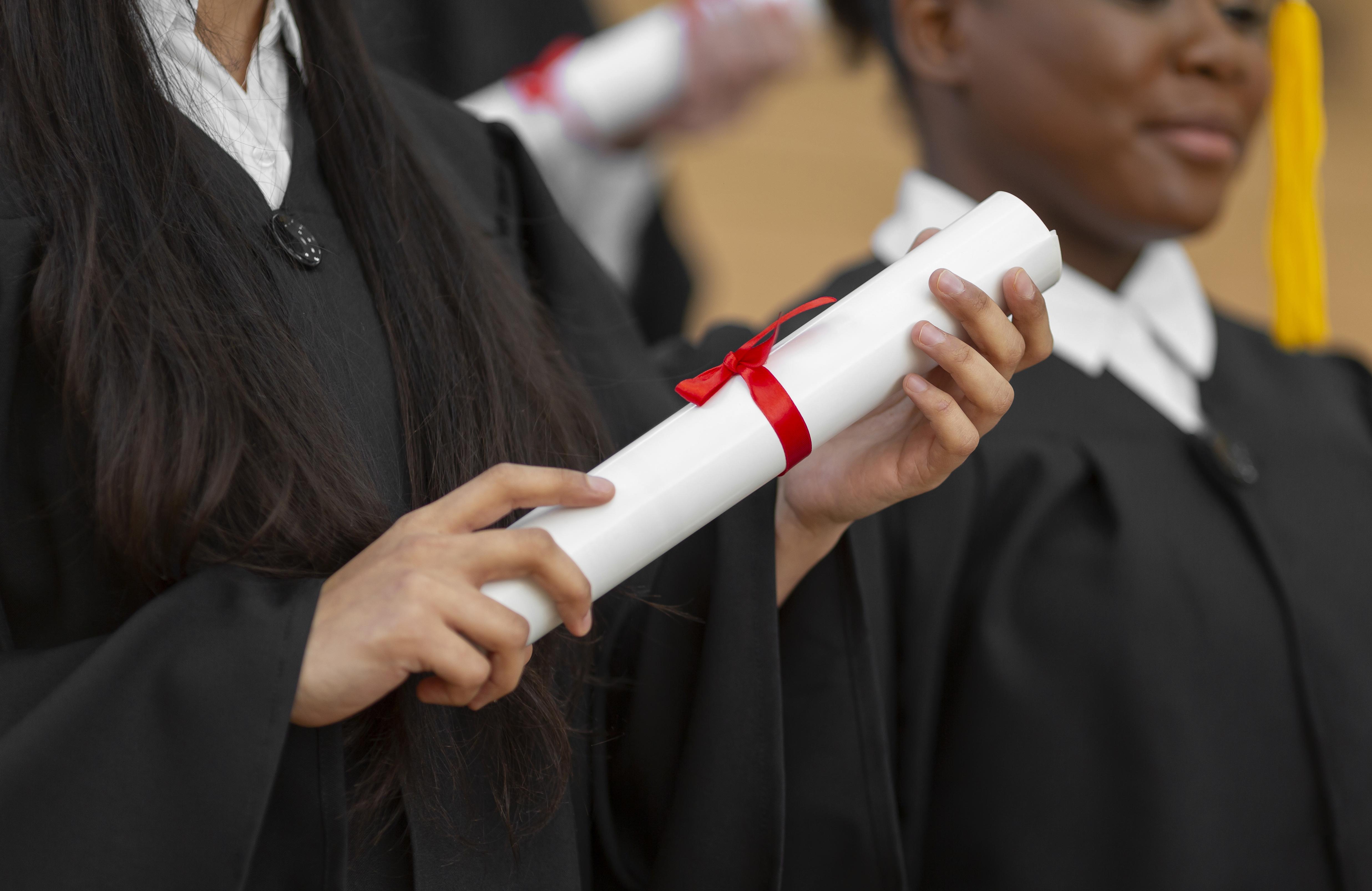 Estudante segurando diploma.